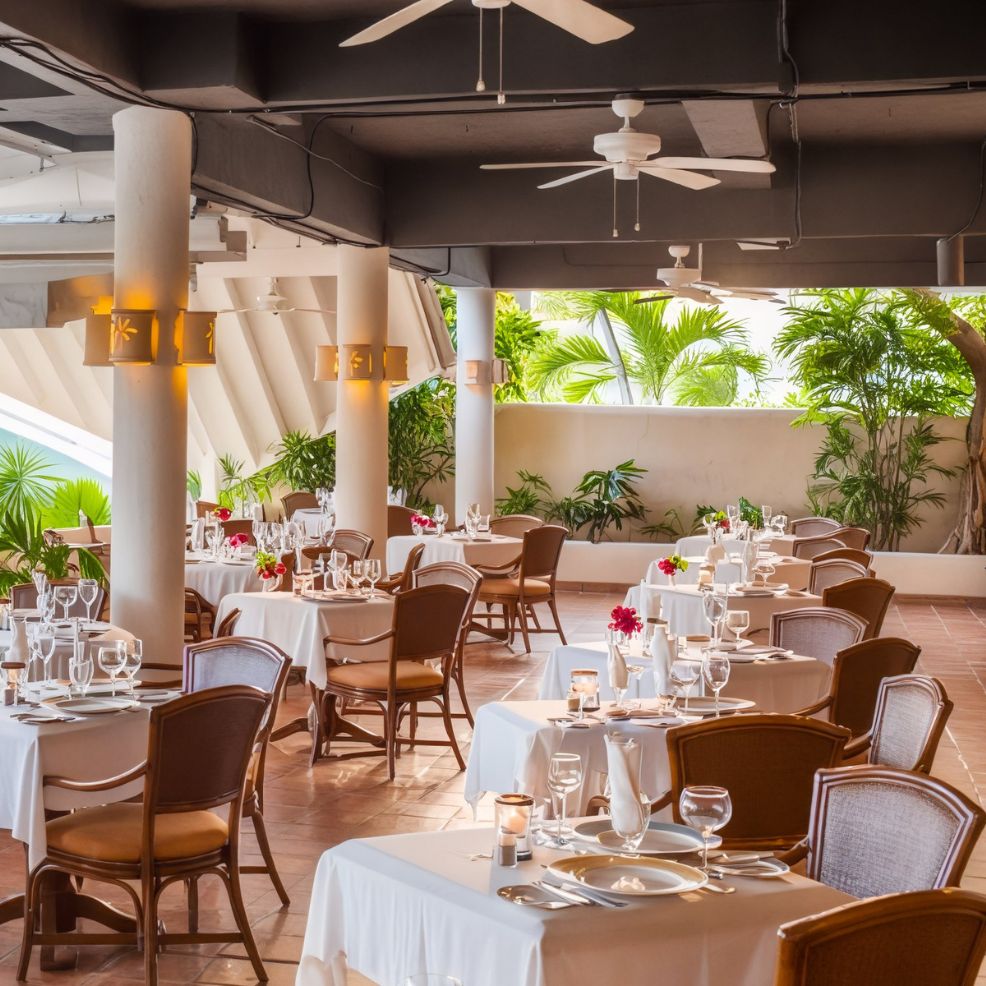 An elegant outdoor venue perfect for a destination wedding, featuring beautifully set tables surrounded by lush tropical plants.