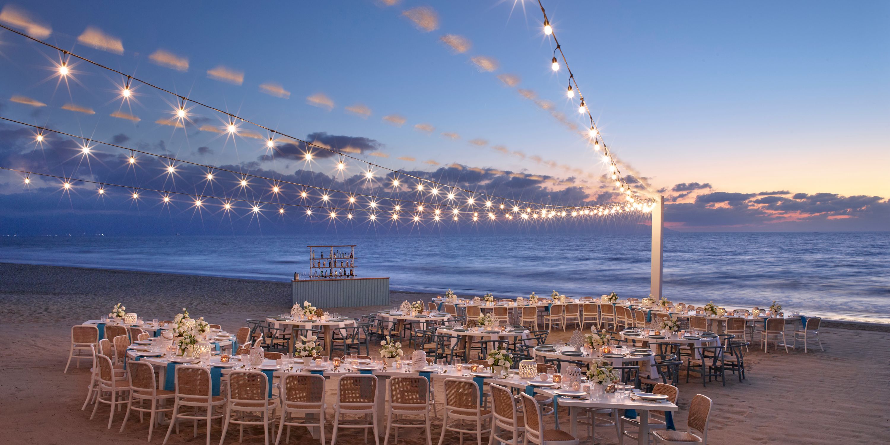 UNICO 20°105° Riviera Nayarit destination wedding beachside dining with string lights at sunset.