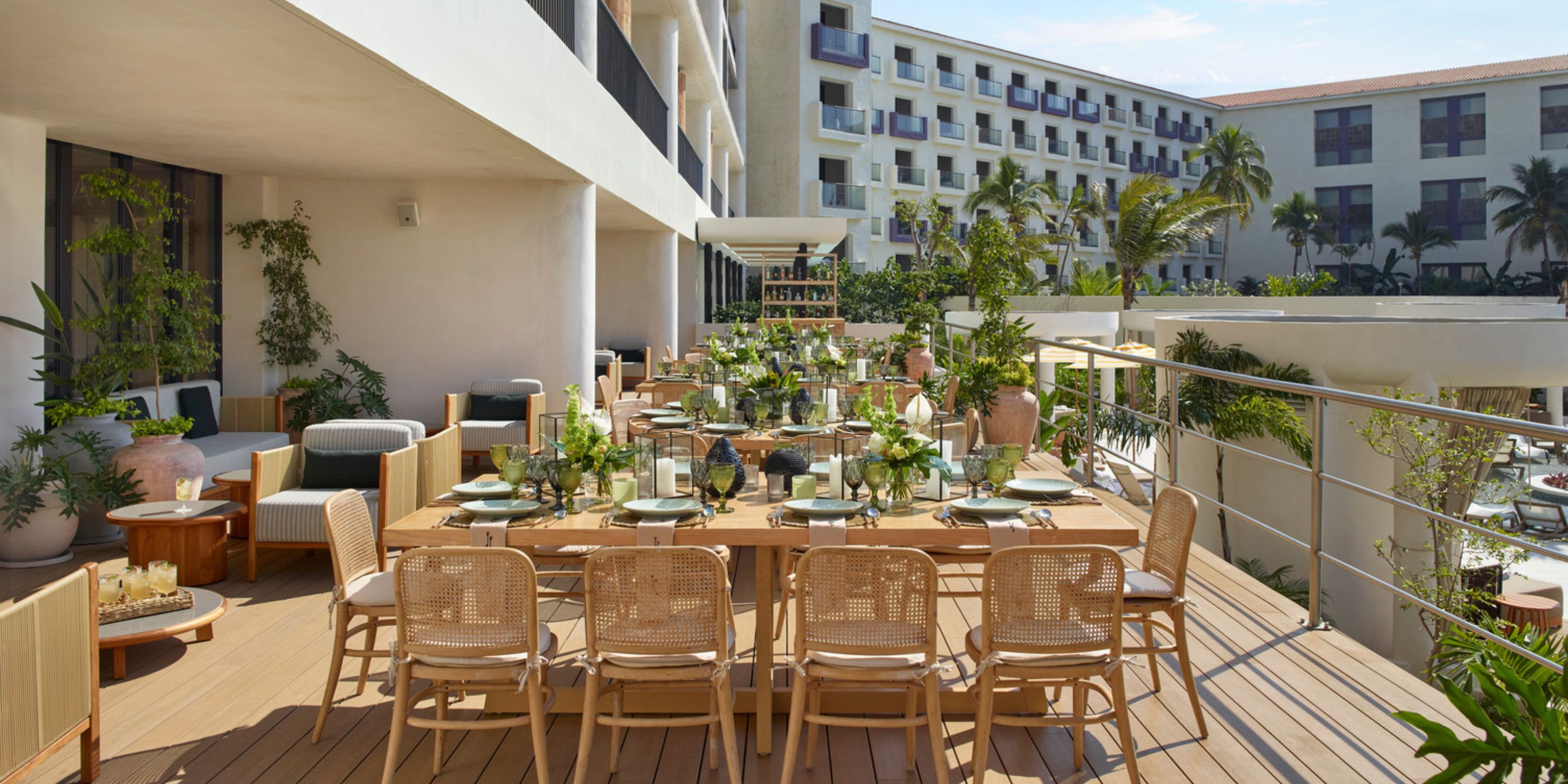Outdoor dining at UNICO 20°105° Riviera Nayarit, ideal for a destination wedding, with wooden tables and lush greenery.