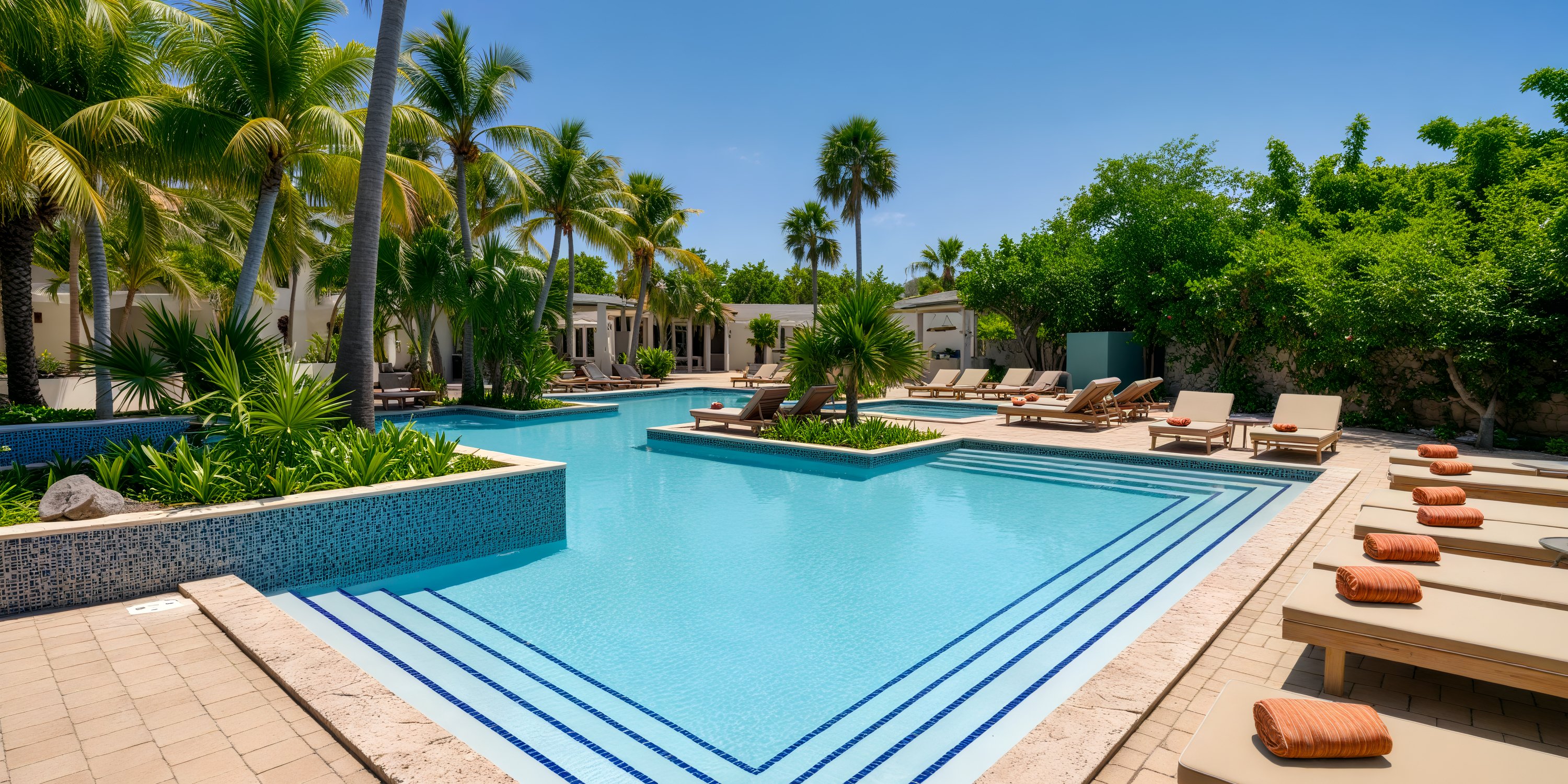 A destination wedding venue featuring an outdoor swimming pool, surrounded by elegant palm trees and luxurious sun loungers.
