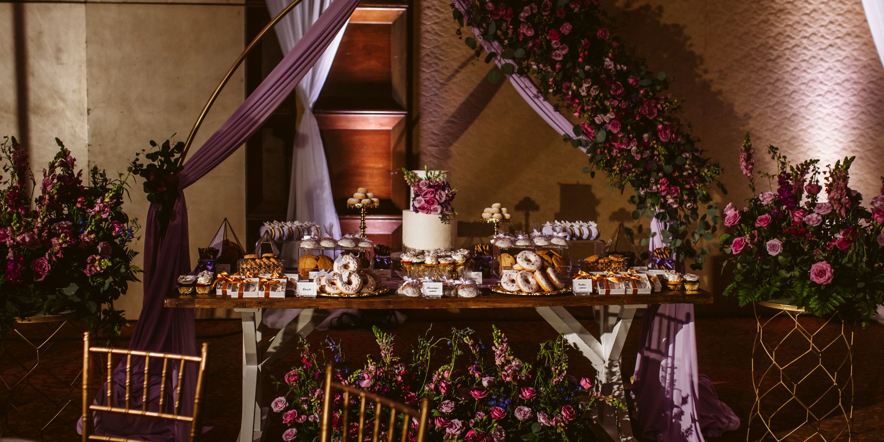 Elegant dessert table at a destination wedding in Moon Palace Nizuc with cake, pastries, and floral décor.