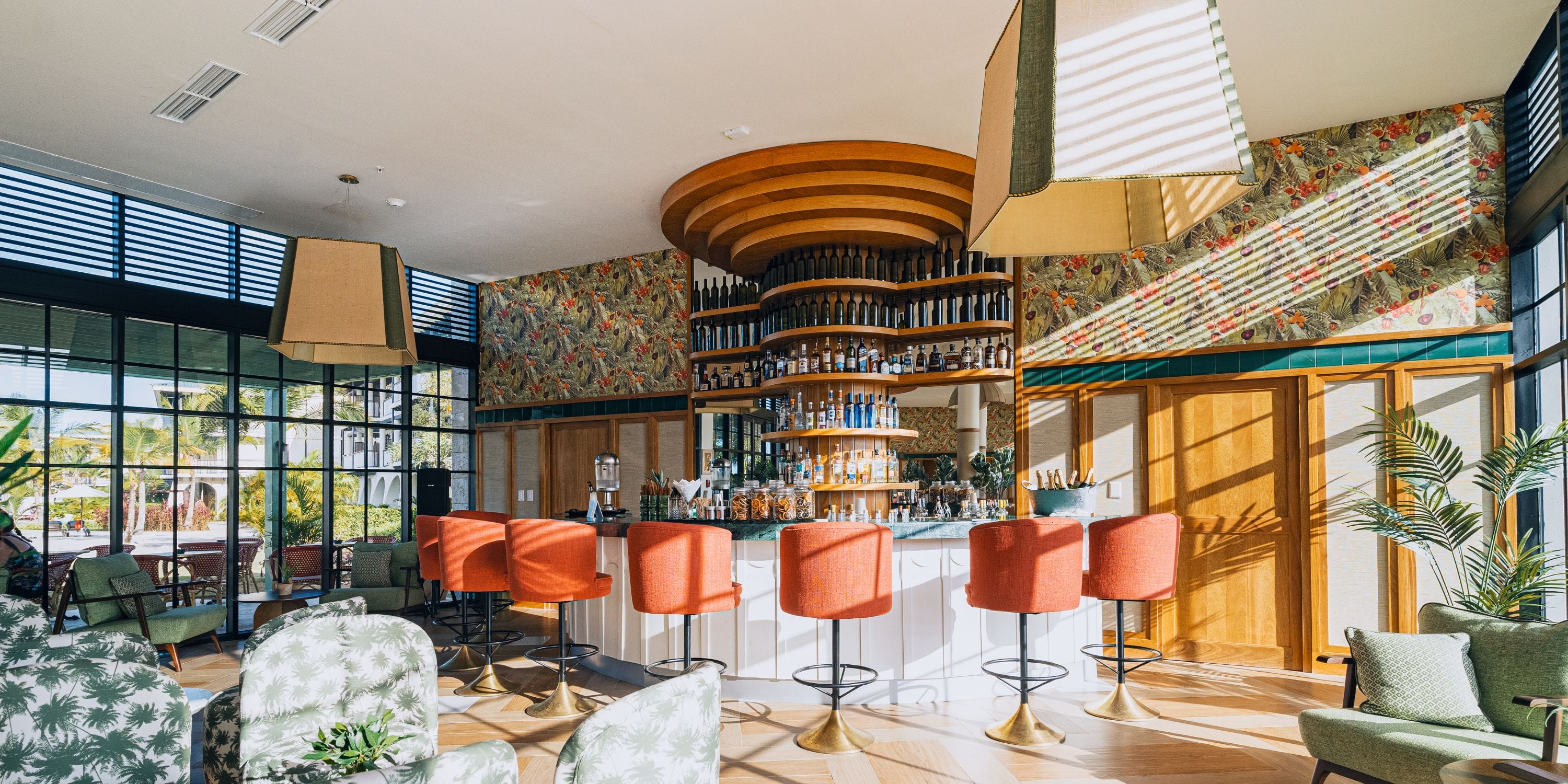 El Beso at Ocean El Faro: stylish bar with orange stools, perfect for a destination wedding venue.