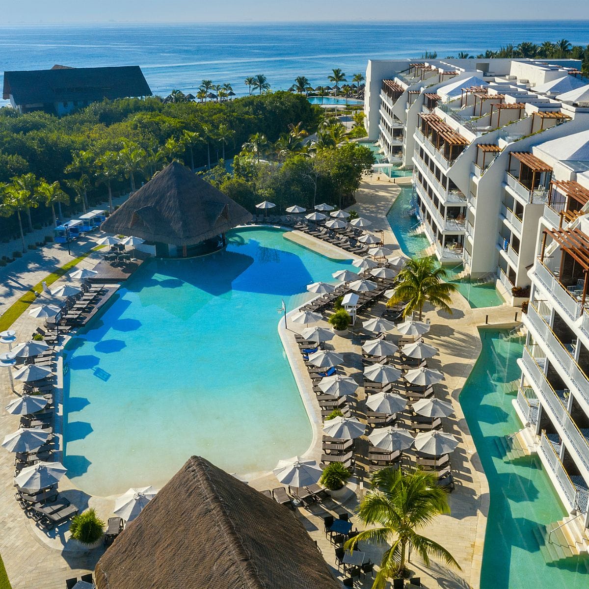 Aerial view of Ocean Riviera Paradise, ideal for a destination wedding, with pools, palms, and ocean backdrop.