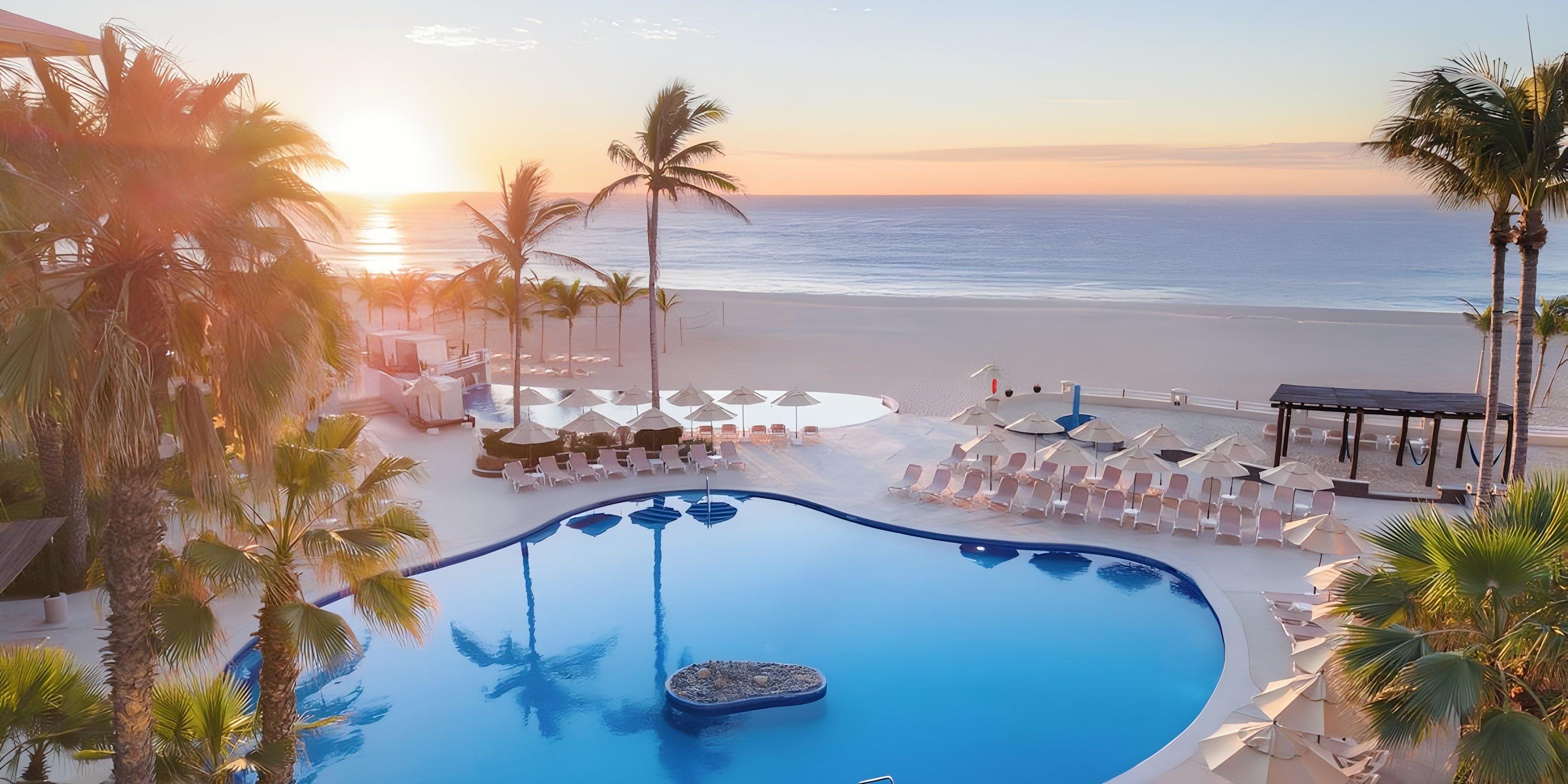 Barceló Grand Faro Los Cabos pool, lounge chairs, and palm trees—perfect for a destination wedding sunrise.