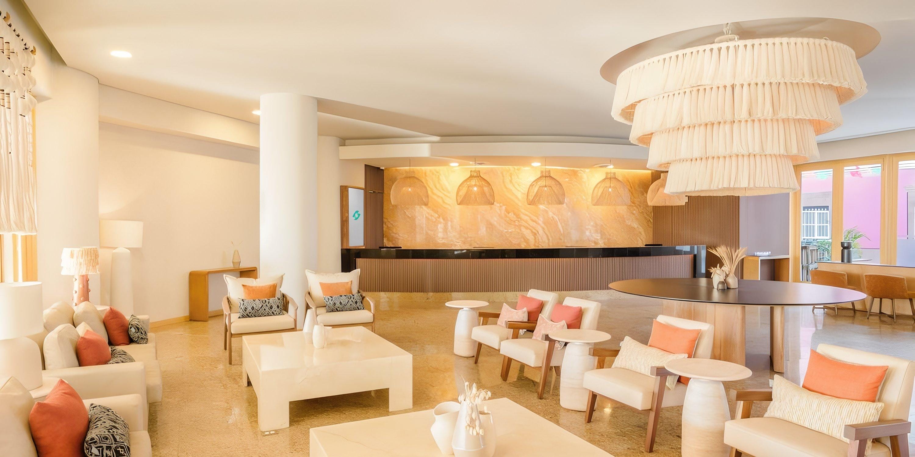 Elegant lobby at Barceló Grand Faro Los Cabos, ideal for destination wedding arrivals, cream decor, chandelier.