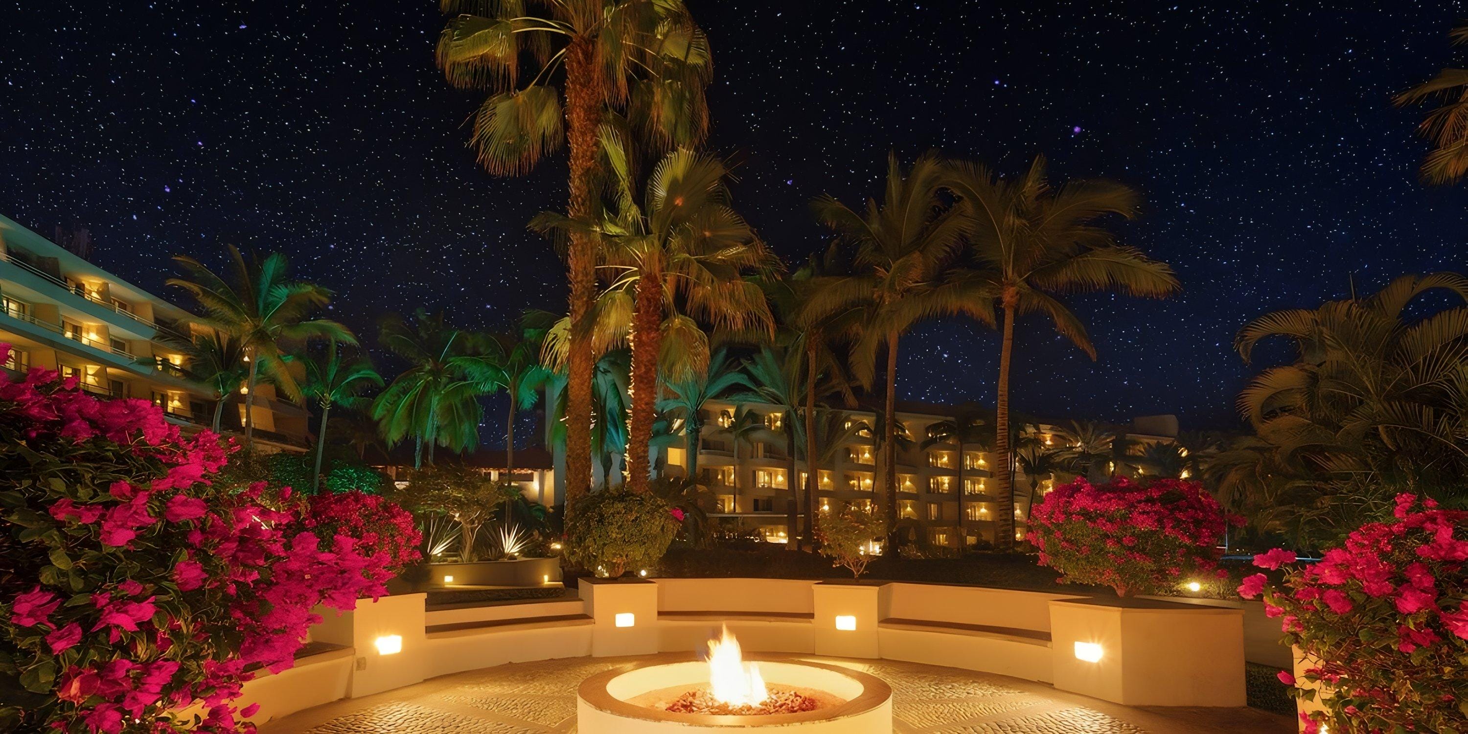 Fire pit at Barceló Grand Faro Los Cabos, perfect for a destination wedding, framed by palms and stars.
