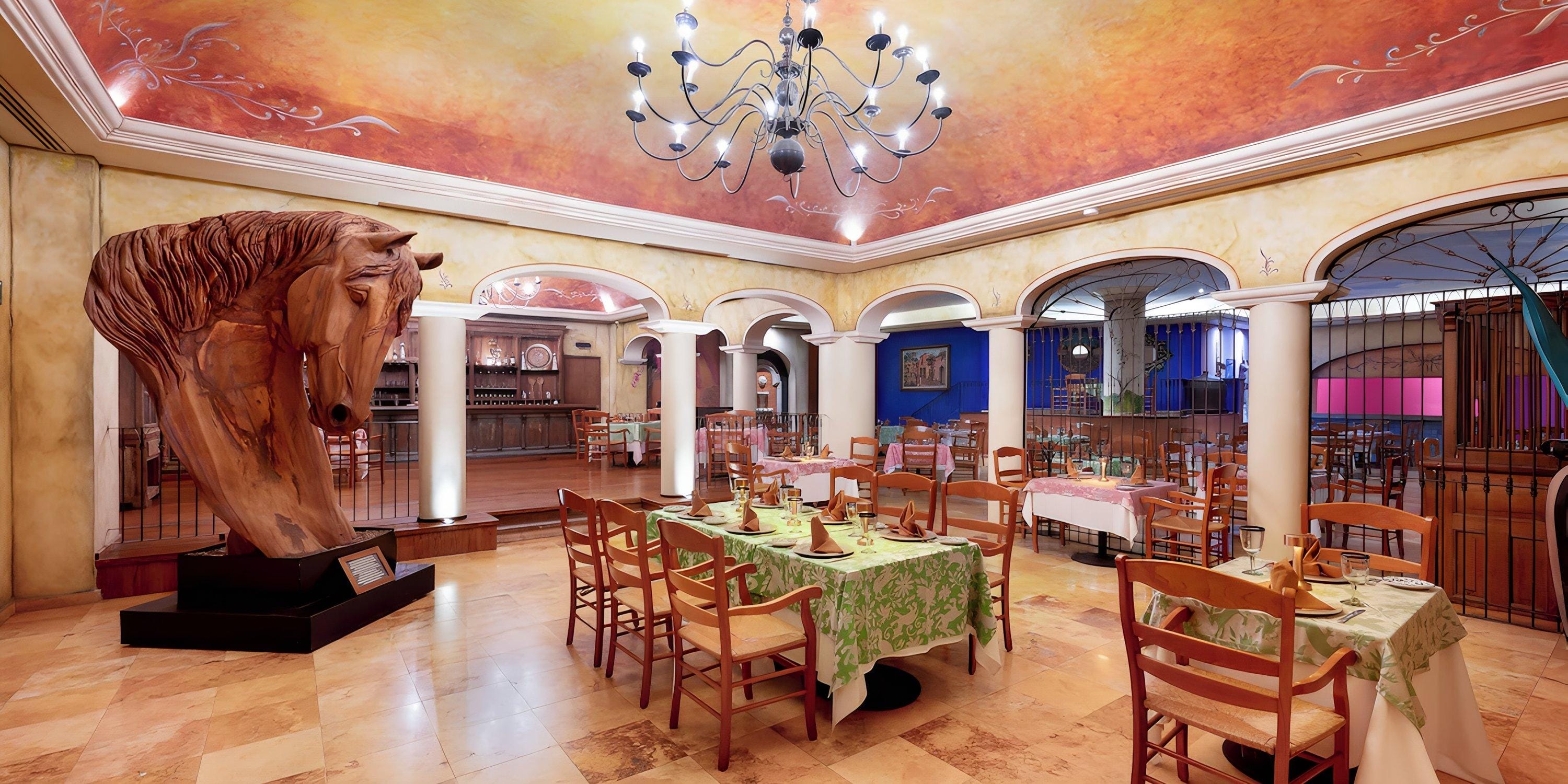 Barceló Grand Faro Los Cabos: wedding decor with wooden horse sculpture, set tables, arches, chandelier.