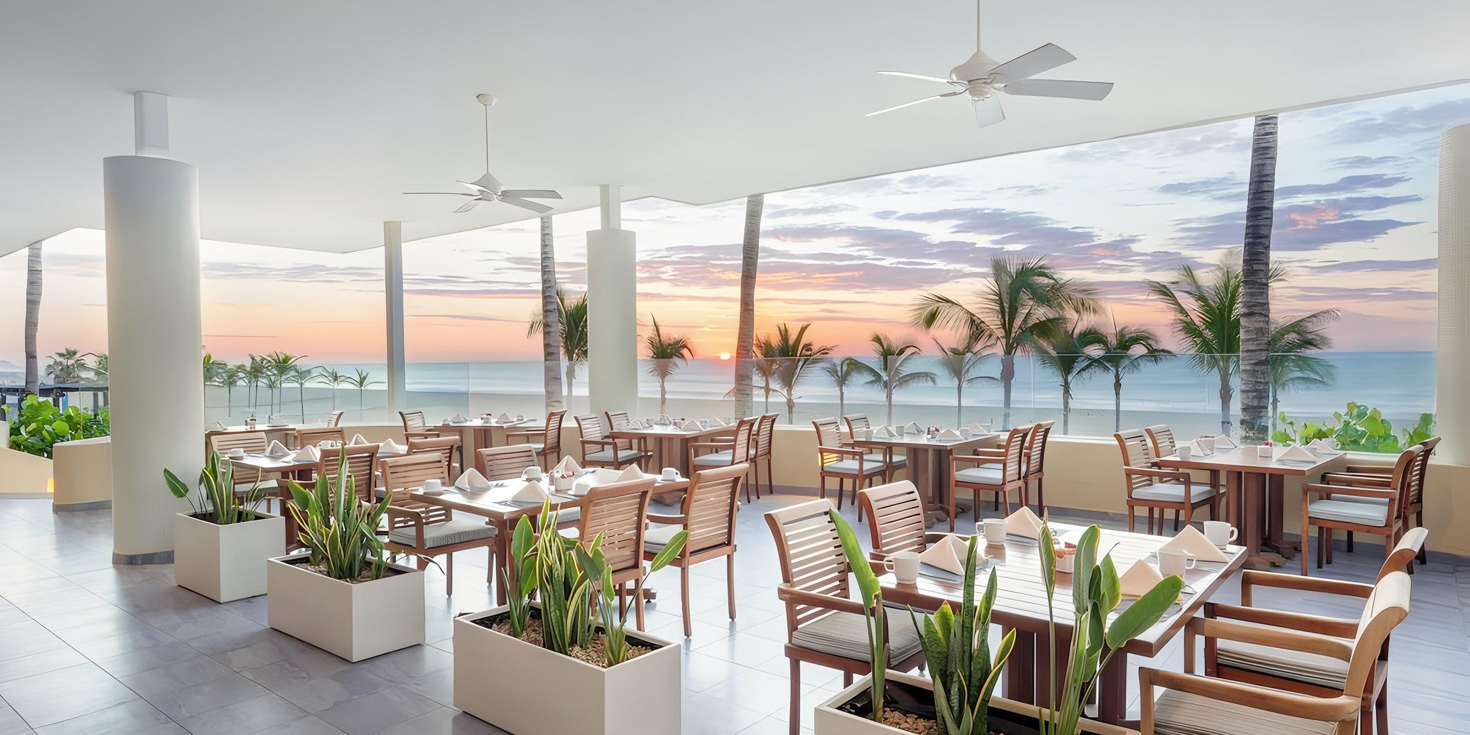 Barceló Grand Faro Los Cabos: open-air dining with wooden tables and sunset views for destination weddings.