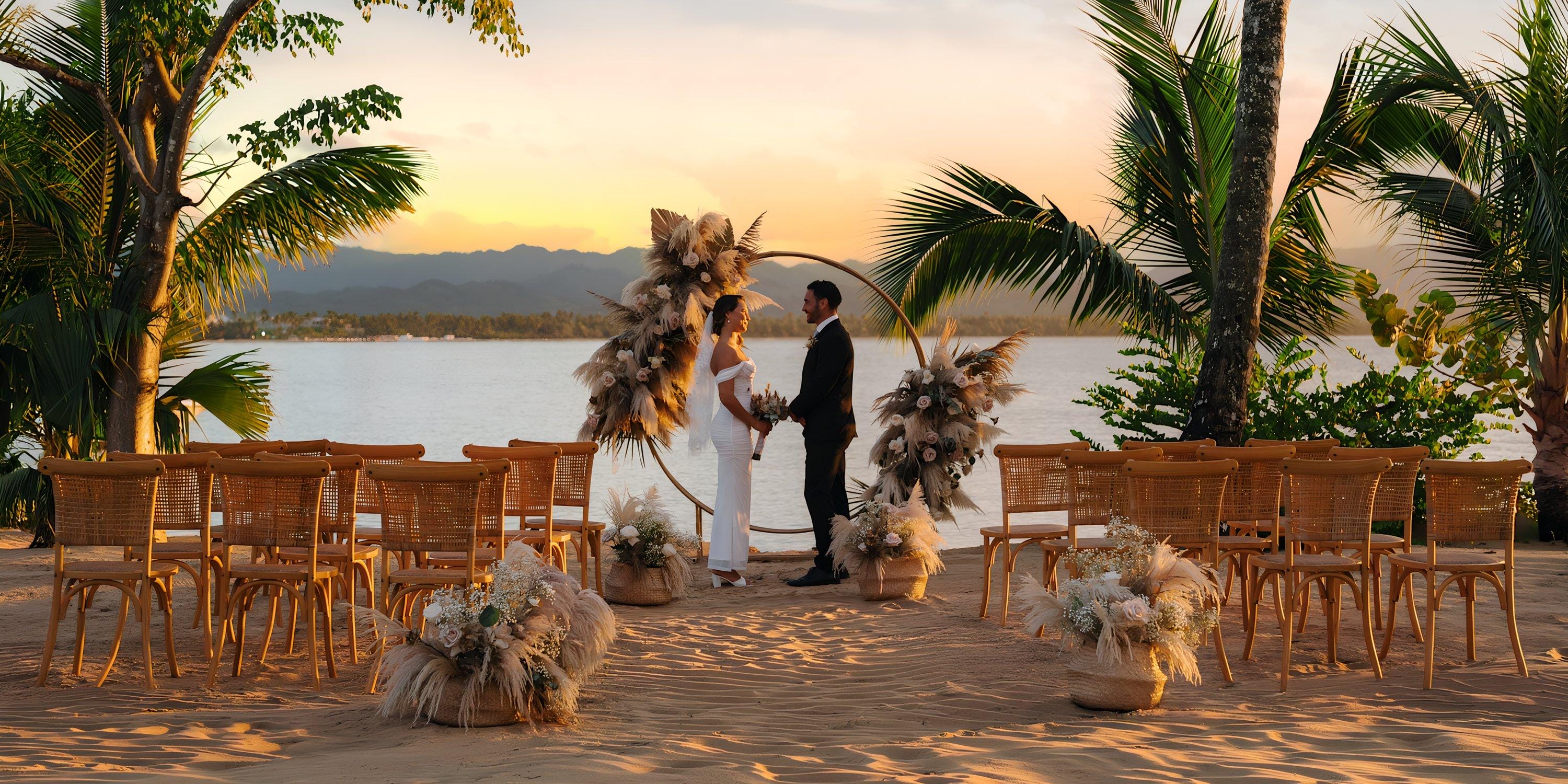 Bride and groom at a sunset destination wedding altar on Hilton Cancun Mar Caribe beach, empty chairs nearby.