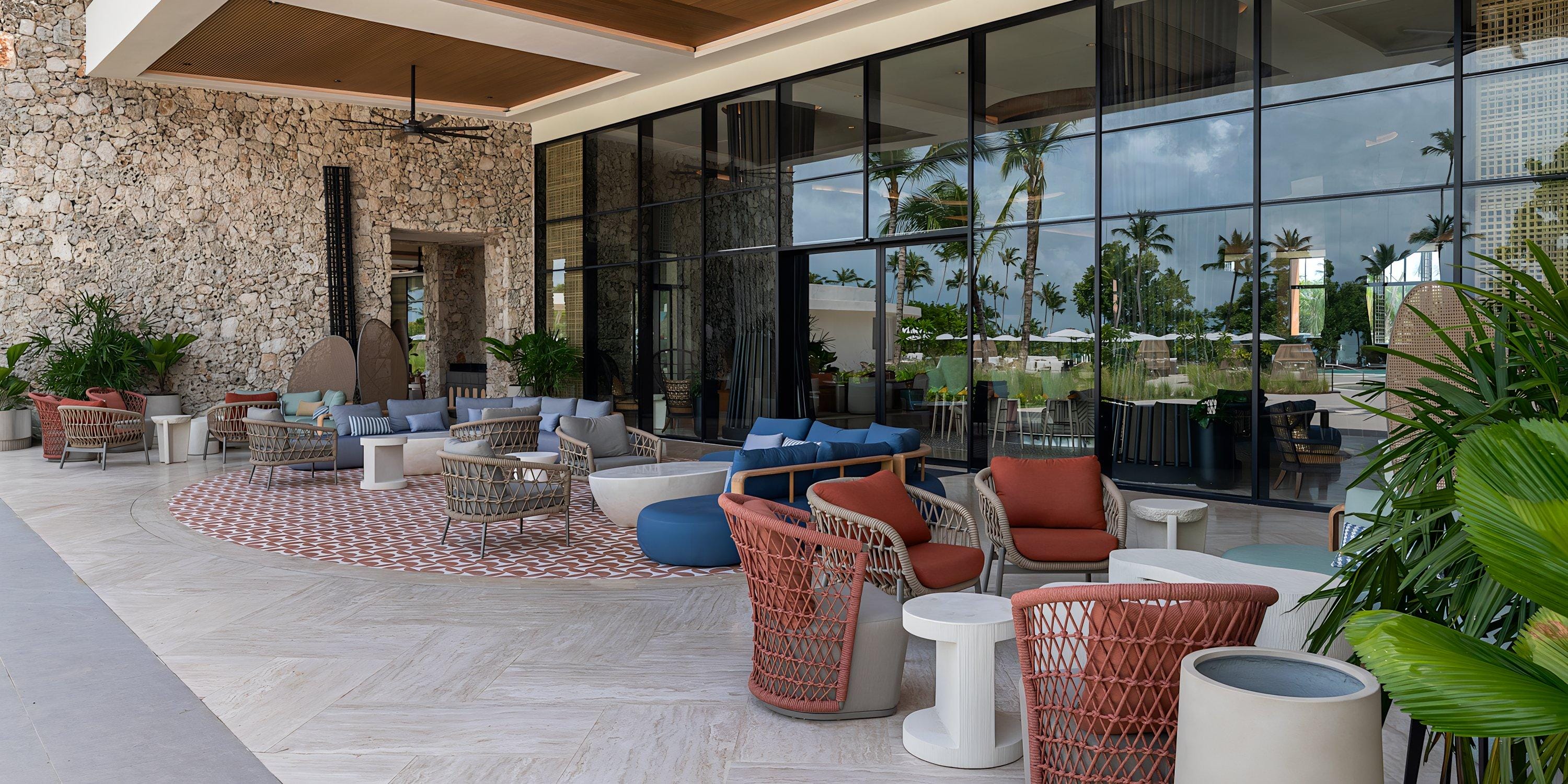 Chic outdoor lounge at Hilton Cancun Mar Caribe, ideal for a destination wedding, with lush plants.