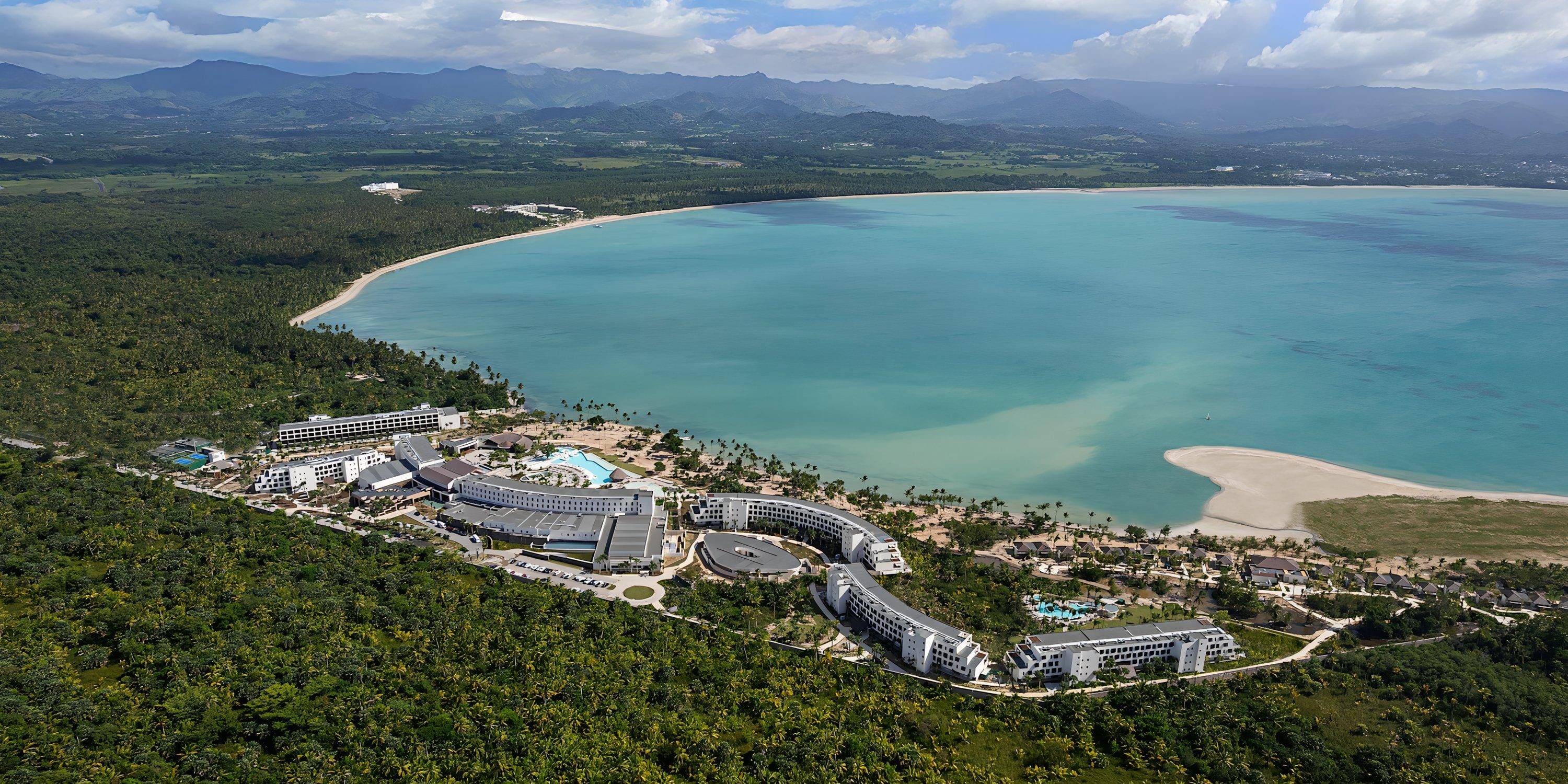 Aerial view of Hilton Cancun Mar Caribe, a stunning destination wedding spot with curved beachfront buildings.