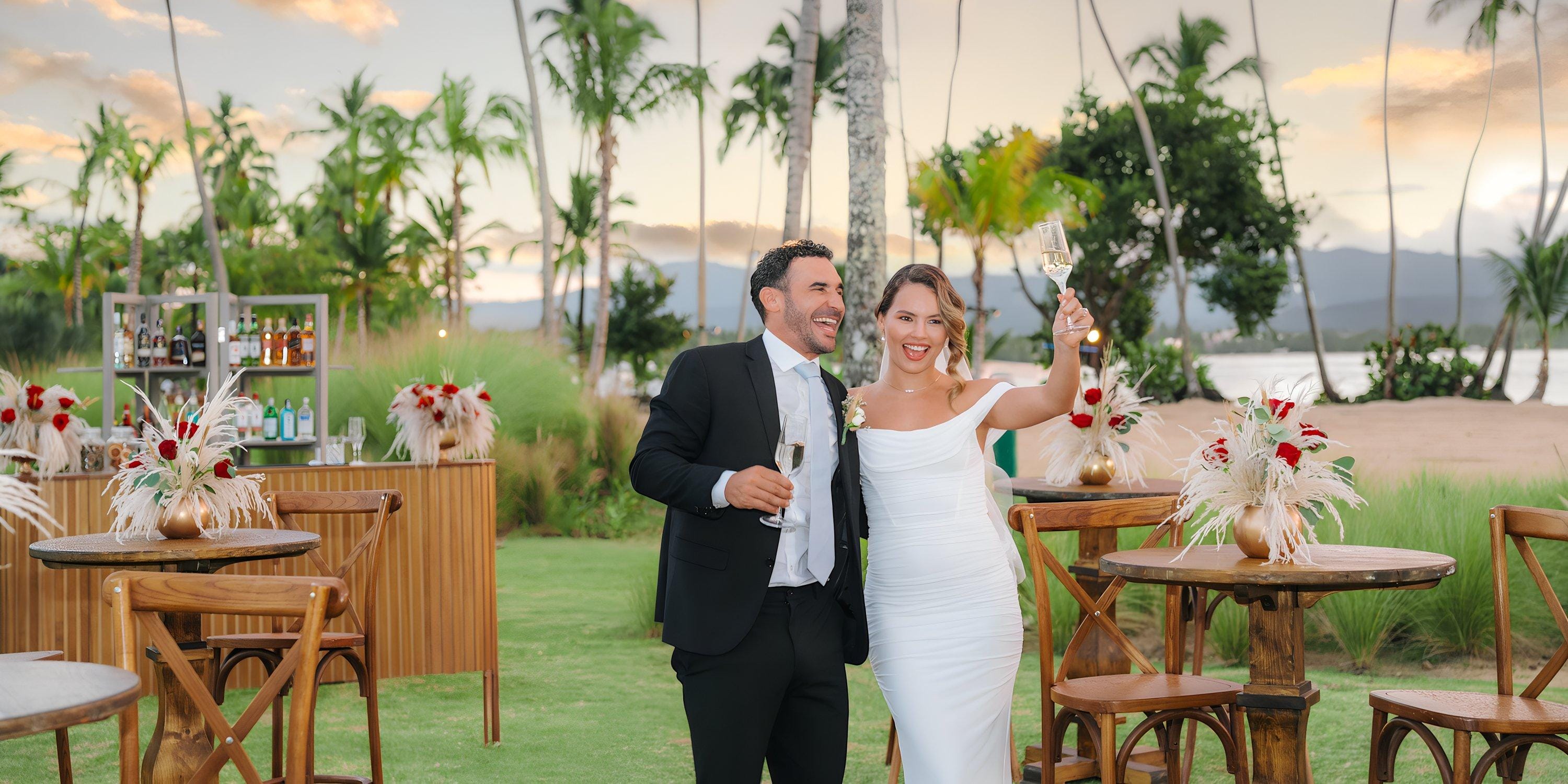 A bride and groom toast with champagne during their destination wedding at Hilton Cancun Mar Caribe.