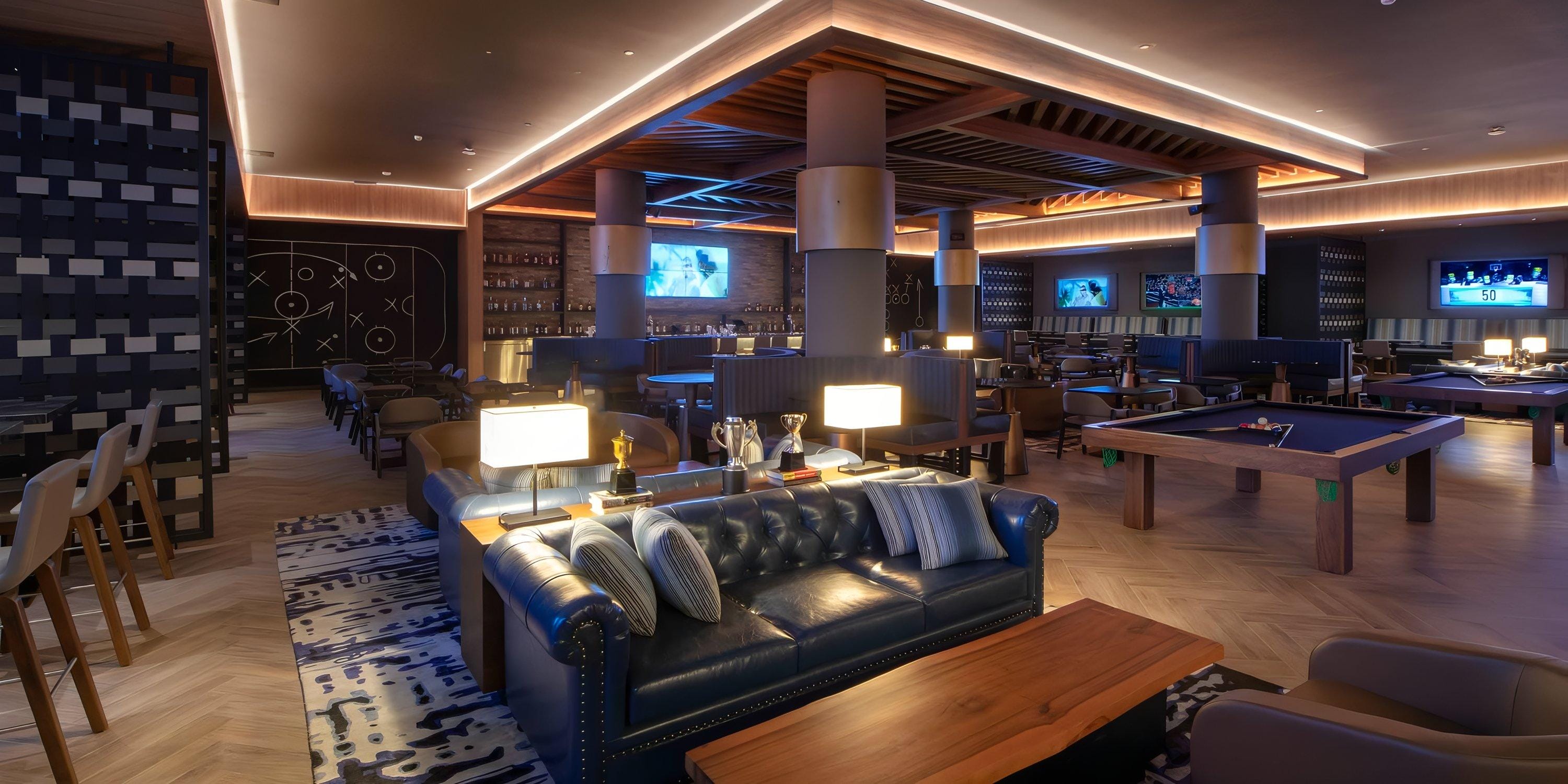 Lopesan Serenity Bay Resort Spa & Casino: cozy lounge, perfect for destination wedding guests, with sofas, pool table, and TVs.