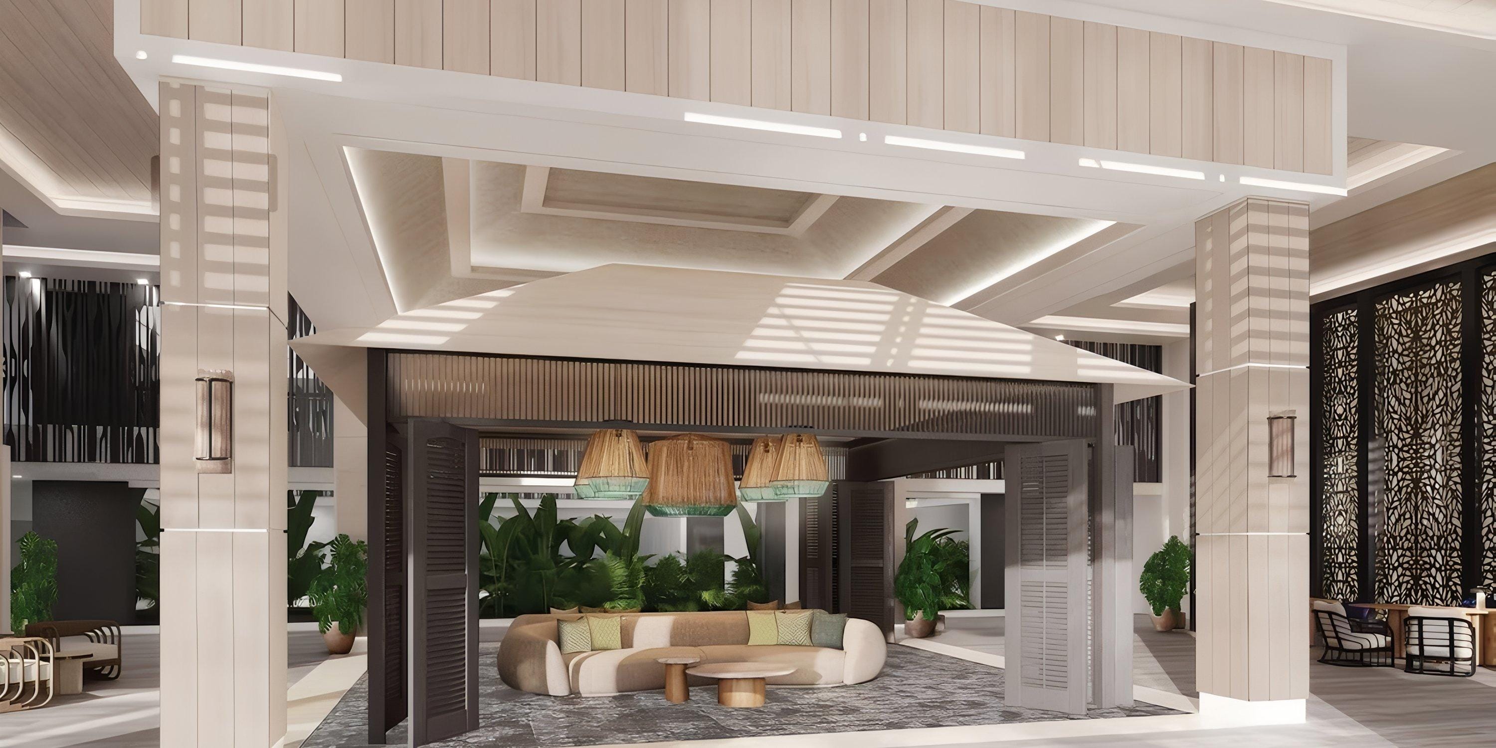 Lopesan Costa Bavaro indoor lounge, ideal for destination weddings, features neutral decor, plants, and pendant lights.