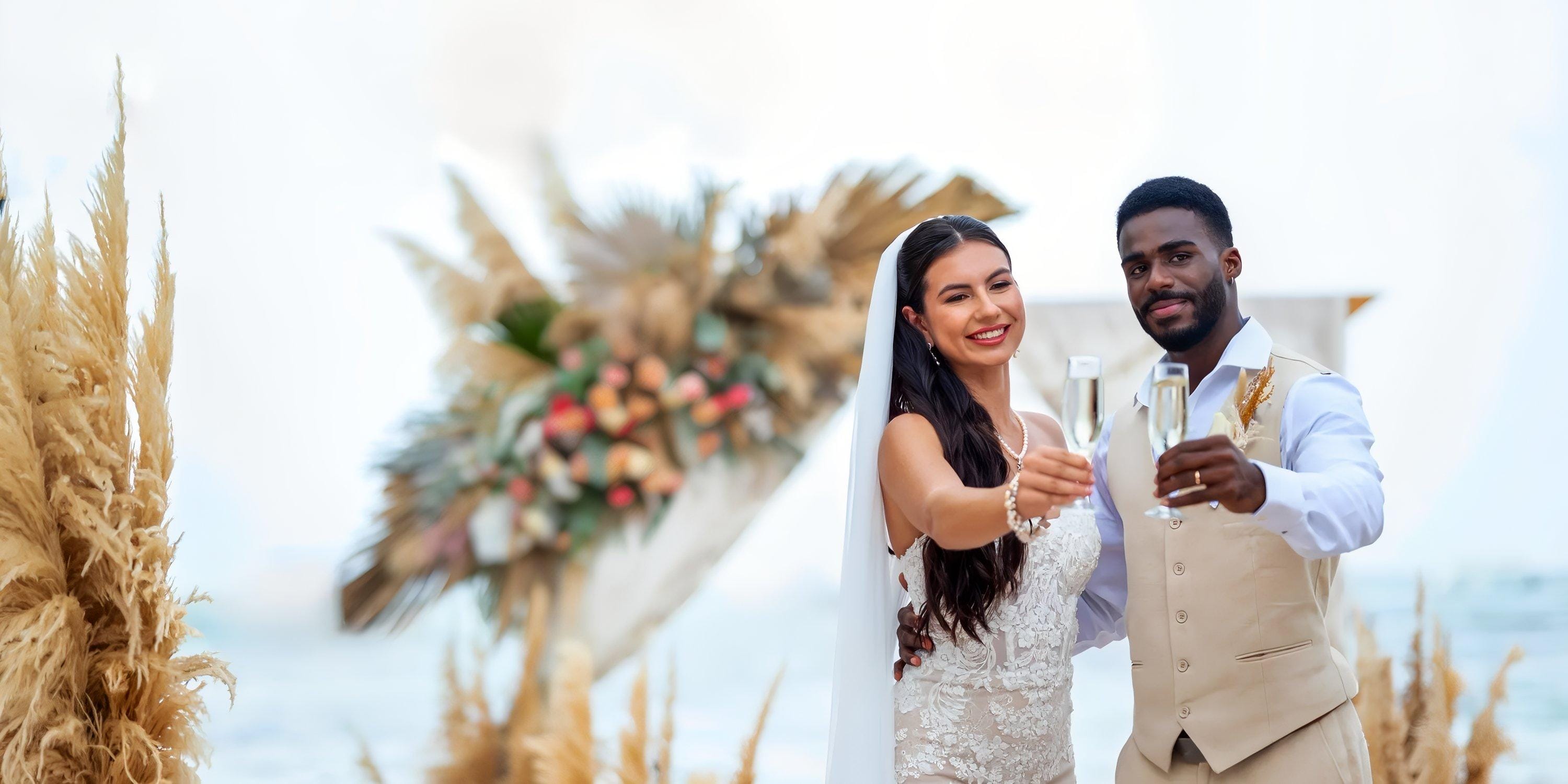 Bride and groom toast with champagne during their destination wedding at Lopesan Costa Bavaro.