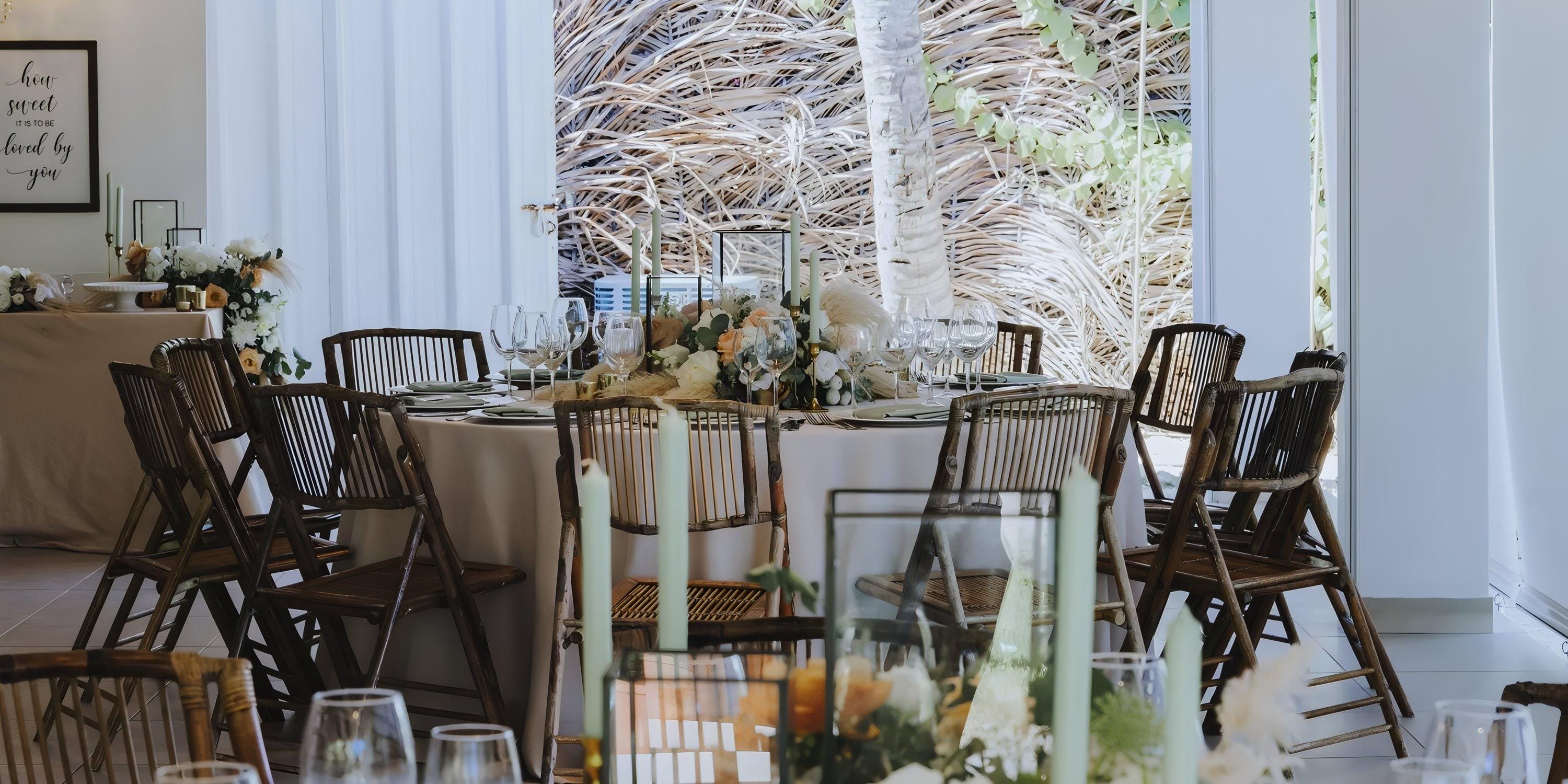 Lopesan Costa Bavaro is set for a destination wedding, with floral centerpieces on round tables.